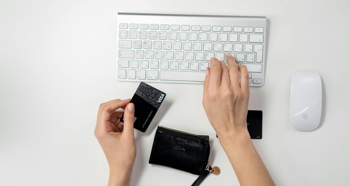 E-commerce setup featuring a keyboard, card, and wallet, ideal for online shopping concepts.